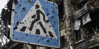 In this photo taken on Sunday, Oct. 25, 2015, a road sign pierced by shrapnel stands at a new terminal of Donetsk Airport destroyed by shelling, in Donetsk, eastern Ukraine. The fighting has subsided, but Donetsk is quickly sinking into the past, a shabby Soviet-like state of empty streets and deprivation. Huge portraits of Josef Stalin hanging in the city center only reinforce the impression of failure. (AP Photo/Max Black)