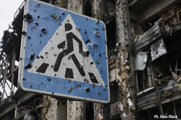 In this photo taken on Sunday, Oct. 25, 2015, a road sign pierced by shrapnel stands at a new terminal of Donetsk Airport destroyed by shelling, in Donetsk, eastern Ukraine. The fighting has subsided, but Donetsk is quickly sinking into the past, a shabby Soviet-like state of empty streets and deprivation. Huge portraits of Josef Stalin hanging in the city center only reinforce the impression of failure. (AP Photo/Max Black)